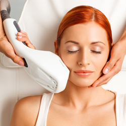 Red-headed model receiving photofacial treatment on her face