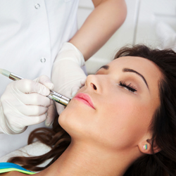 Brunette model undergoing skin treatment on her face