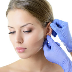 Female model's ear being examined